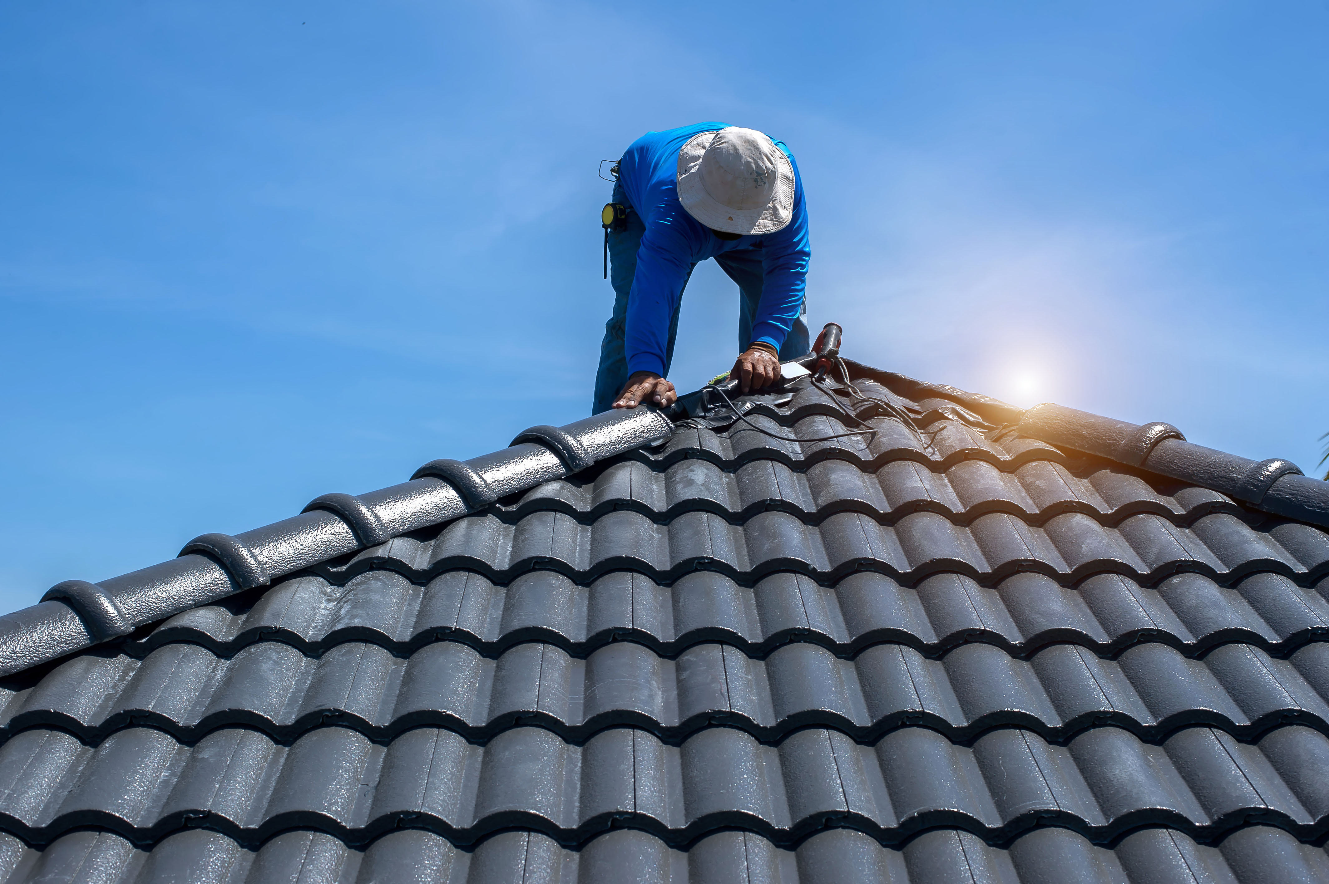 Roof restoration in progress by a BGT Roofing crew
